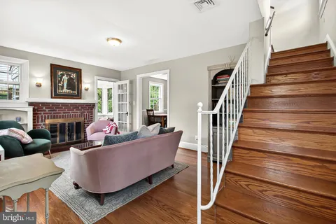 a living room with furniture a fireplace and a large window