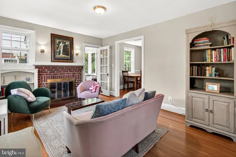 a living room with furniture a rug and a fireplace