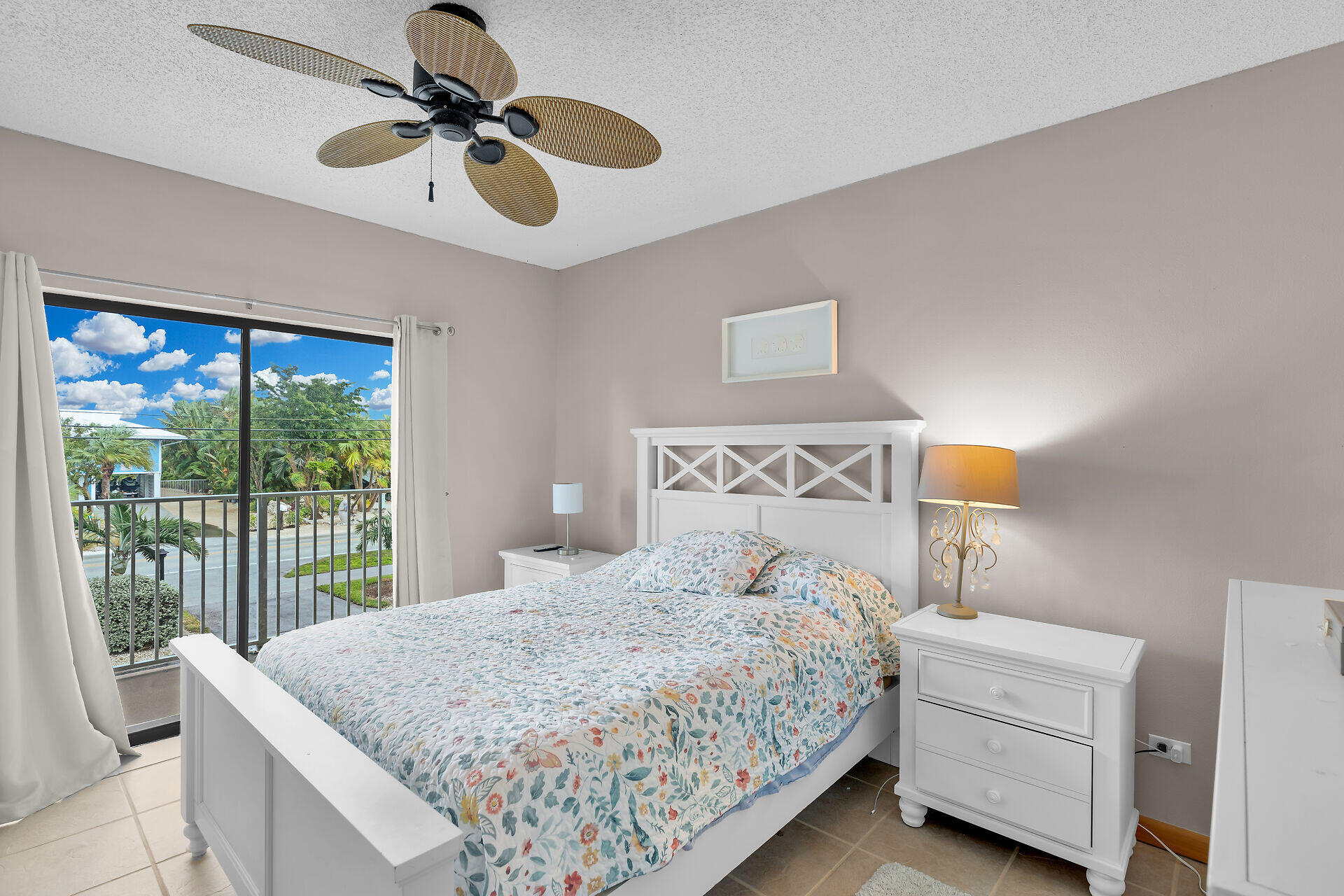 423 Sombrero Beach Road, Unit 9 Marathon, FL 33050 - Photo 14 of 42 a bedroom with a bed and a chandelier