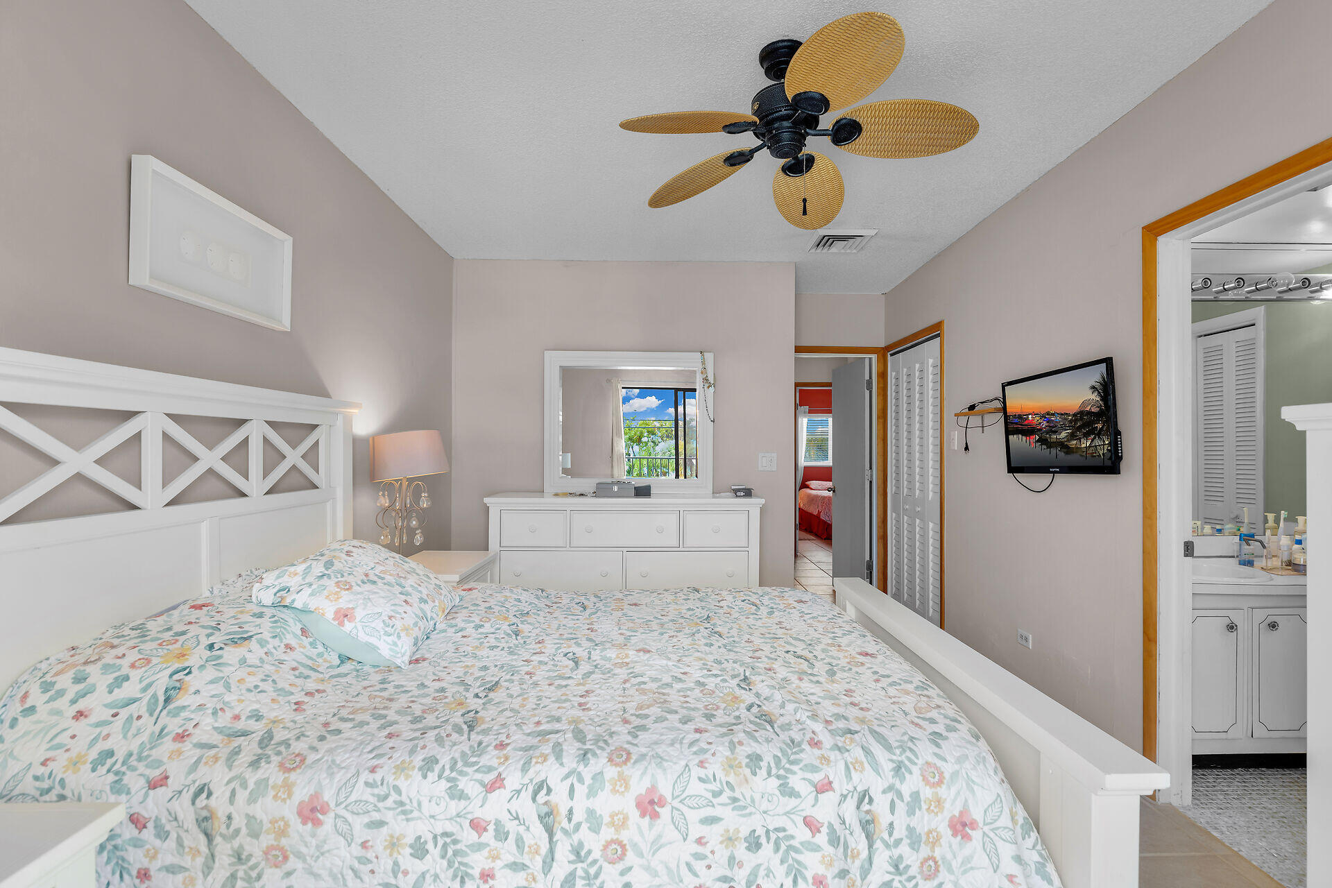 423 Sombrero Beach Road, Unit 9 Marathon, FL 33050 - Photo 15 of 42 a bedroom with a bed and a chandelier