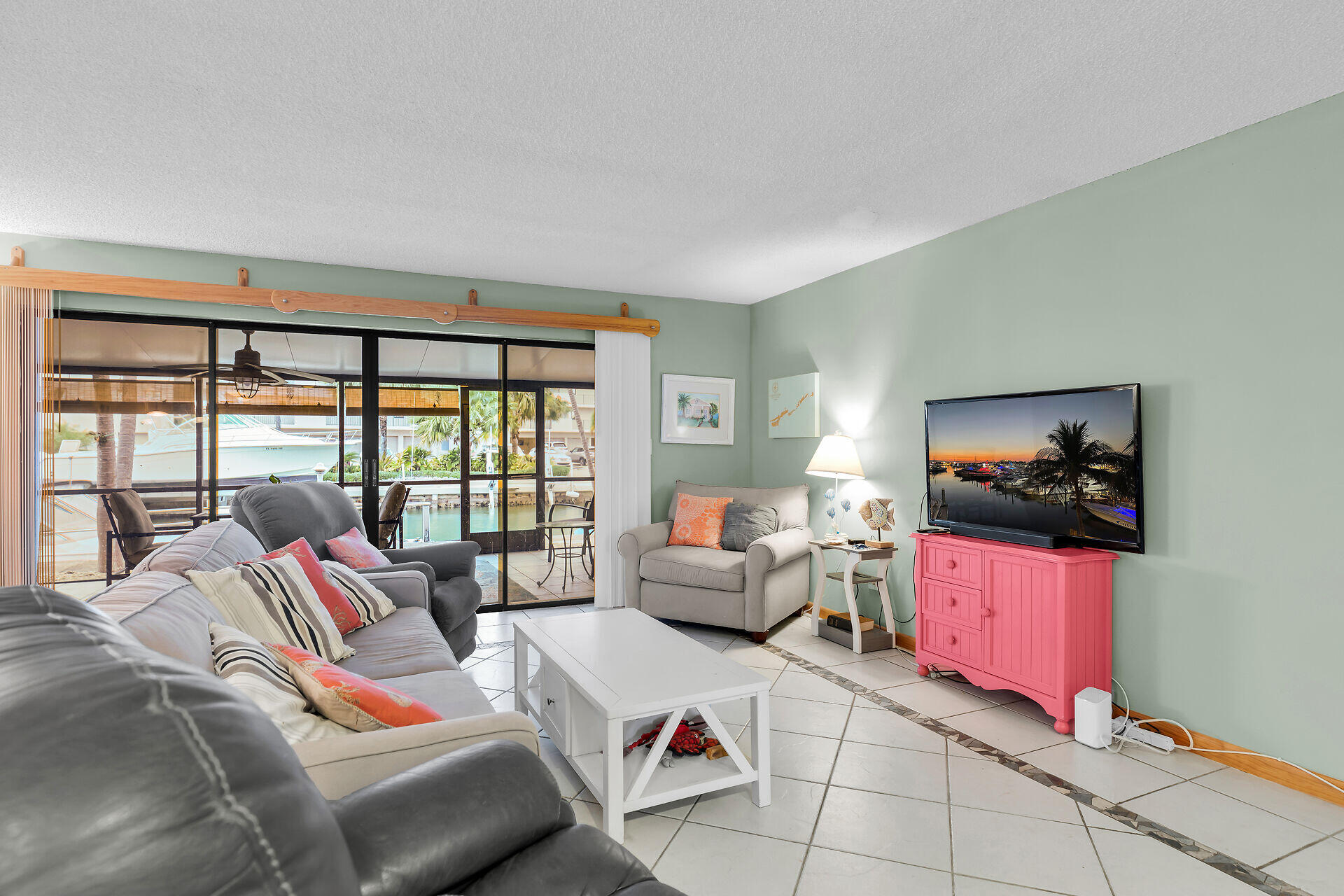 423 Sombrero Beach Road, Unit 9 Marathon, FL 33050 - Photo 6 of 42 a living room with furniture and a flat screen tv