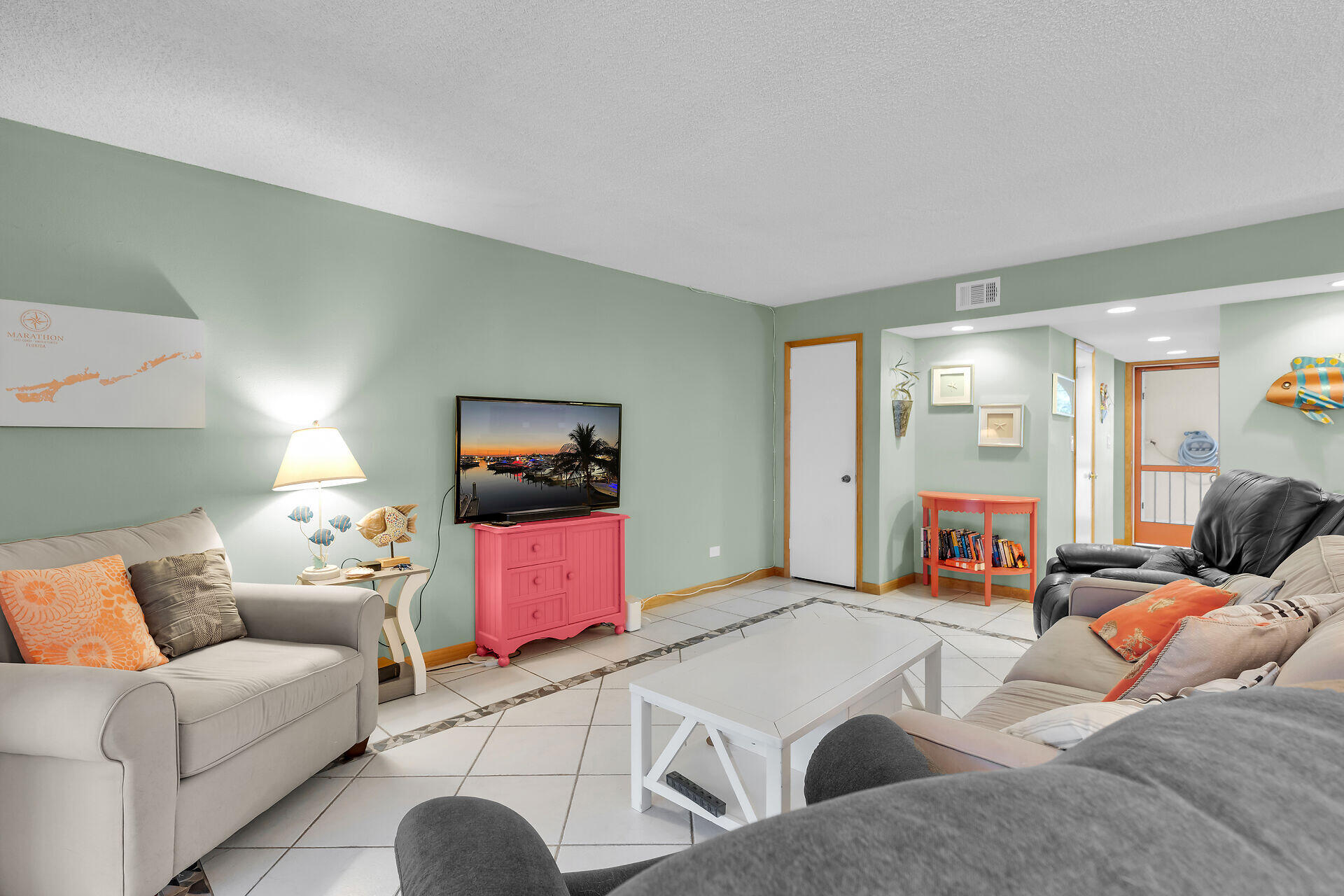 423 Sombrero Beach Road, Unit 9 Marathon, FL 33050 - Photo 7 of 42 a living room with furniture and a flat screen tv