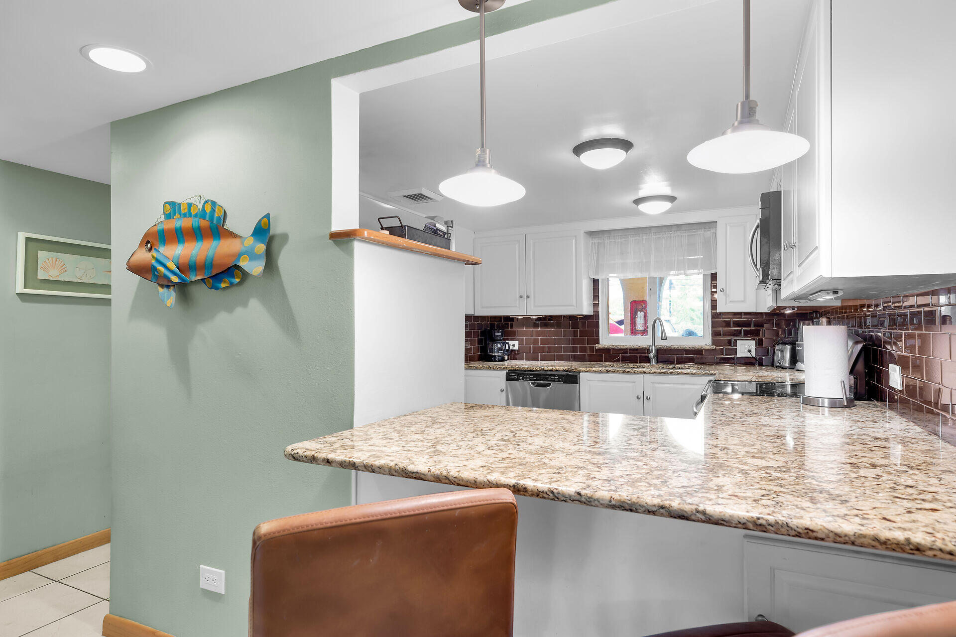 423 Sombrero Beach Road, Unit 9 Marathon, FL 33050 - Photo 9 of 42 a kitchen with stainless steel appliances granite countertop a sink a stove and a wooden floors
