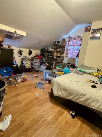 a bedroom with furniture and a flat screen tv