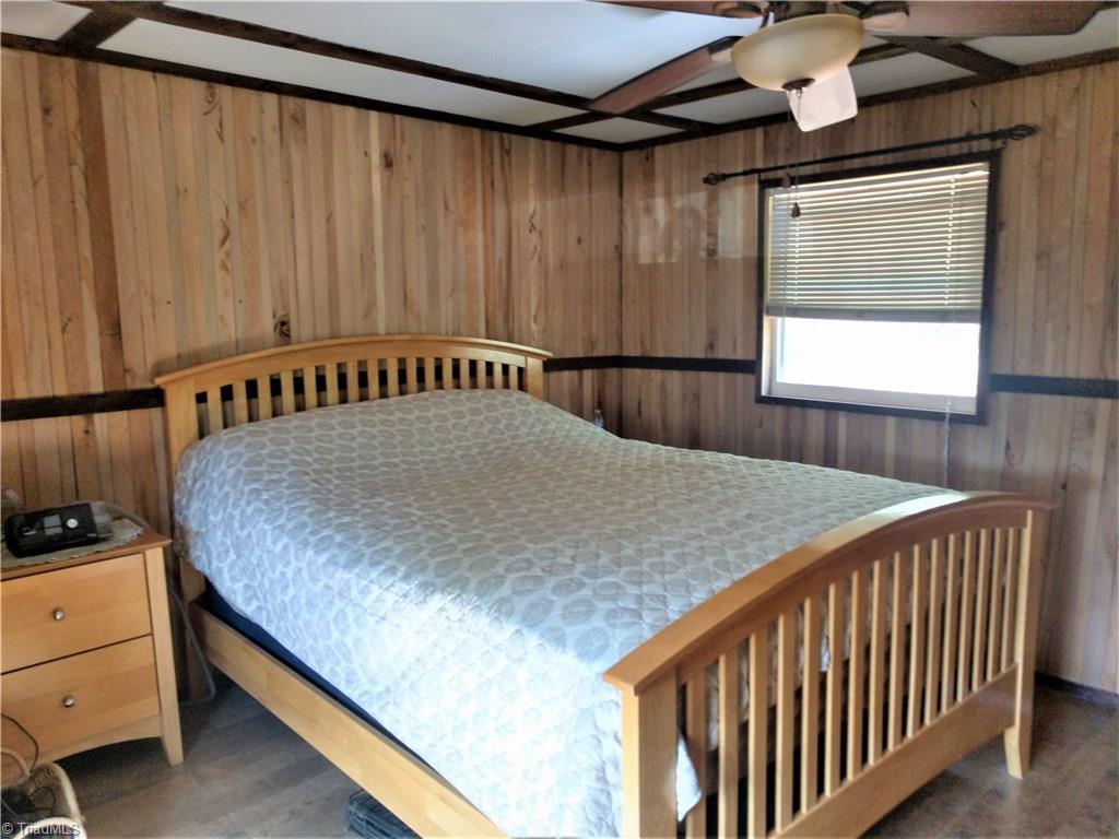 5712 Hayes Farm Road Seagrove, NC 27341 - Photo 7 of 16 Master Bedroom - Wood Walls, Updated Flooring