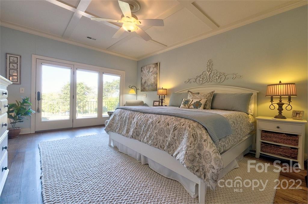 475 Beacon Knoll Lane Fort Mill, SC 29708 - Photo 13 of 43 a spacious bedroom with a bed a chandelier and a window