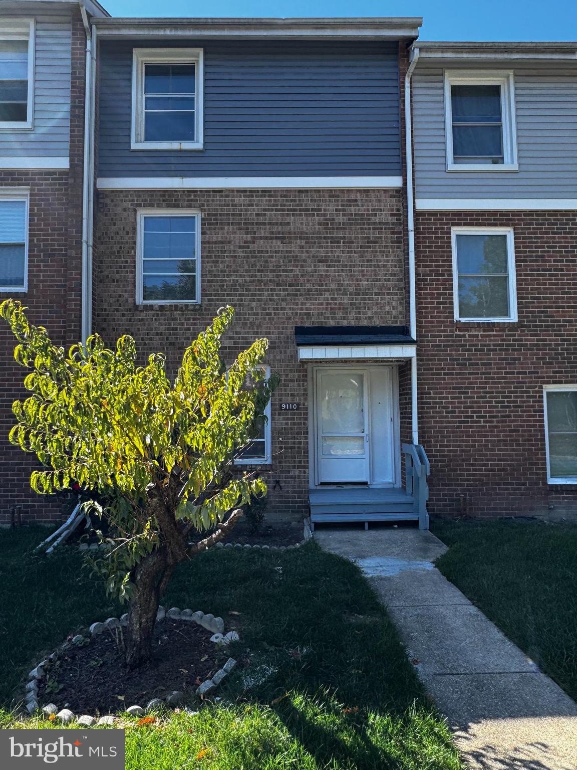 9110 Canterbury Riding, Unit 129 Laurel, MD 20723 - Photo 1 of 20 a front view of a house with a yard