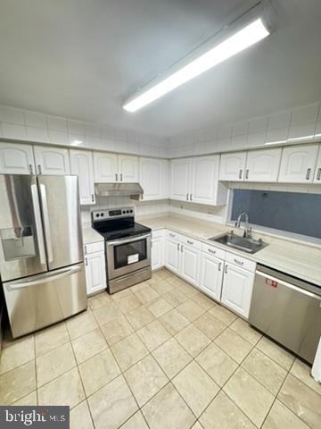 9110 Canterbury Riding, Unit 129 Laurel, MD 20723 - Photo 2 of 20 a kitchen with granite countertop a refrigerator and a stove top oven