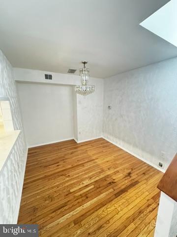 9110 Canterbury Riding, Unit 129 Laurel, MD 20723 - Photo 4 of 20 a bedroom with a bed and wooden floor