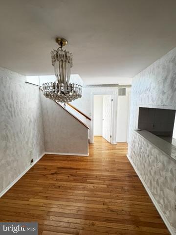 9110 Canterbury Riding, Unit 129 Laurel, MD 20723 - Photo 9 of 20 a view of a livingroom with wooden floor and a chandelier