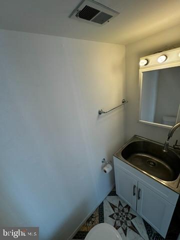 9110 Canterbury Riding, Unit 129 Laurel, MD 20723 - Photo 10 of 20 a bathroom with a sink and cabinets