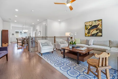 a living room with furniture and wooden floor