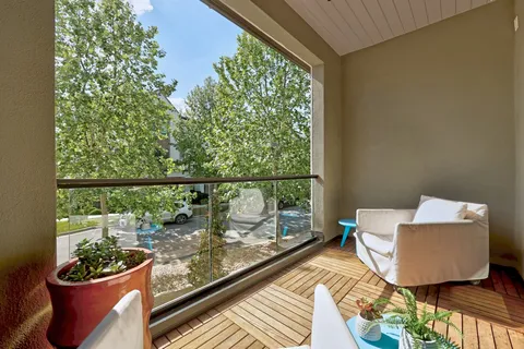 a view of a balcony with chair and potted plant