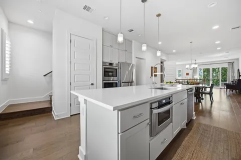 a kitchen with a stove a sink and a refrigerator