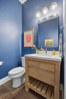 a bathroom with a toilet a sink and mirror