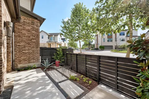a street view with a couple of cars parked in front of a house