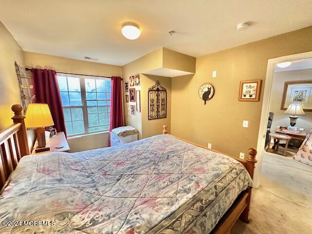 185 Liddle Avenue Edison, NJ 08837 - Photo 10 of 19 a bedroom with a bed and dresser with mirror