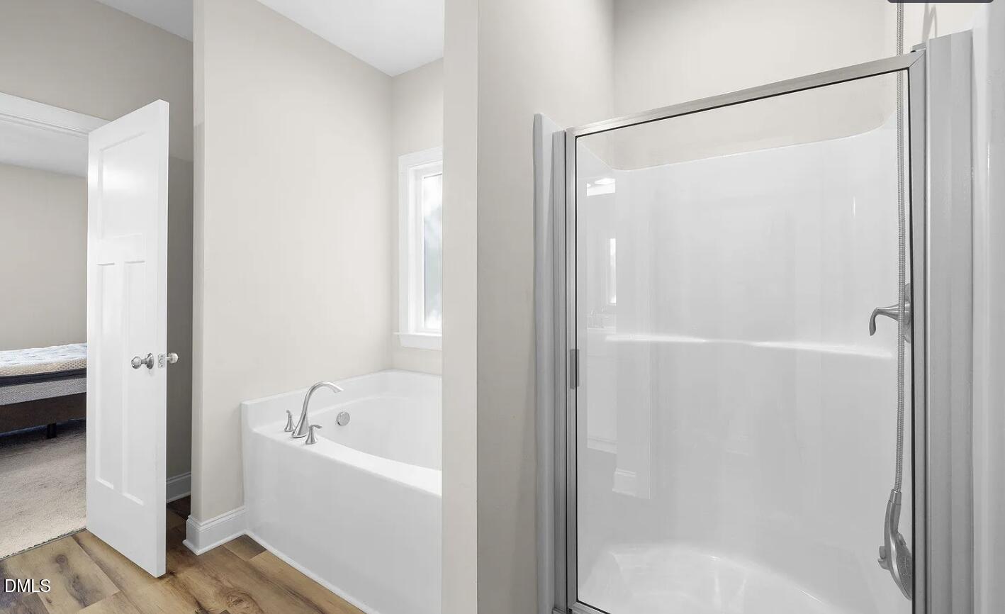 202 South 6th Street Erwin, NC 28339 - Photo 18 of 35 a bathroom with a bathtub and a shower