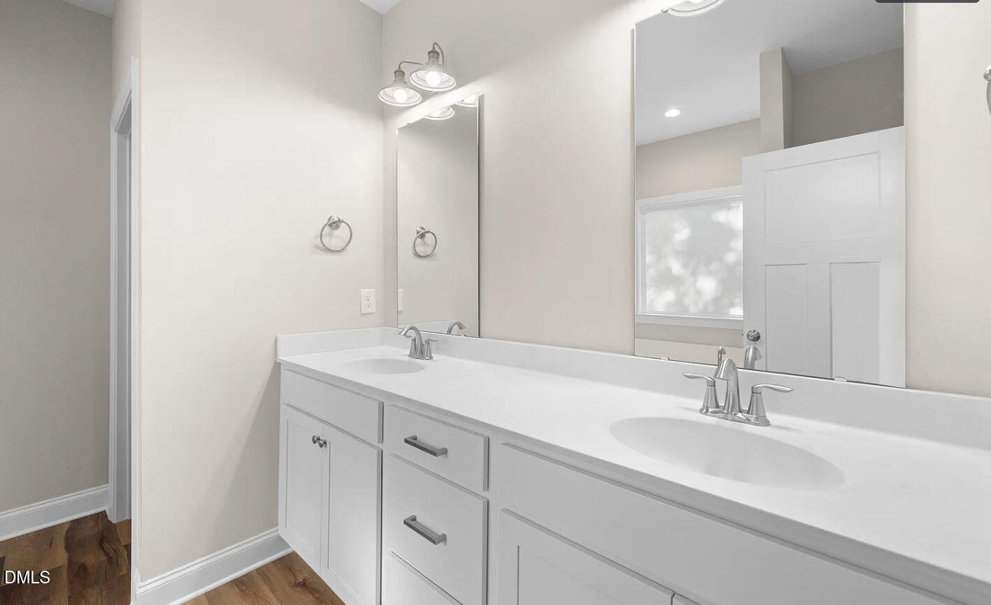 202 South 6th Street Erwin, NC 28339 - Photo 19 of 35 a bathroom with double sink and a mirror