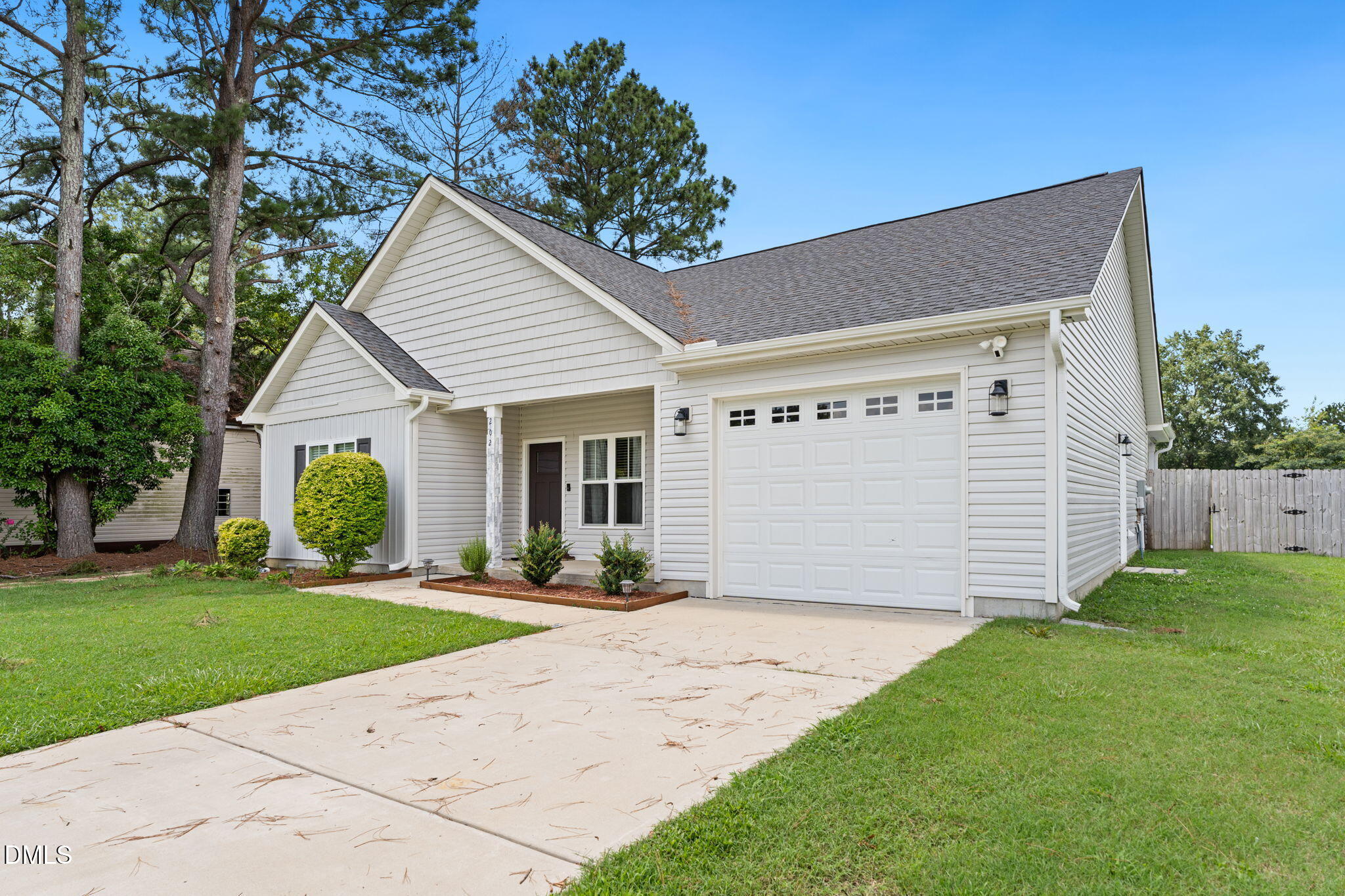 202 South 6th Street Erwin, NC 28339 - Photo 4 of 35 a front view of a house with a yard and garage