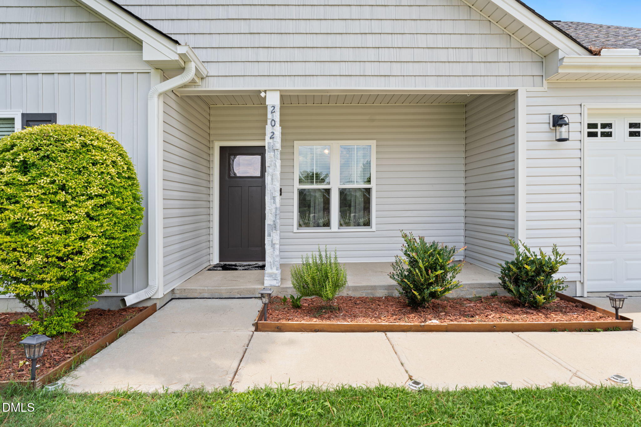 202 South 6th Street Erwin, NC 28339 - Photo 5 of 35 a front view of a house with garden