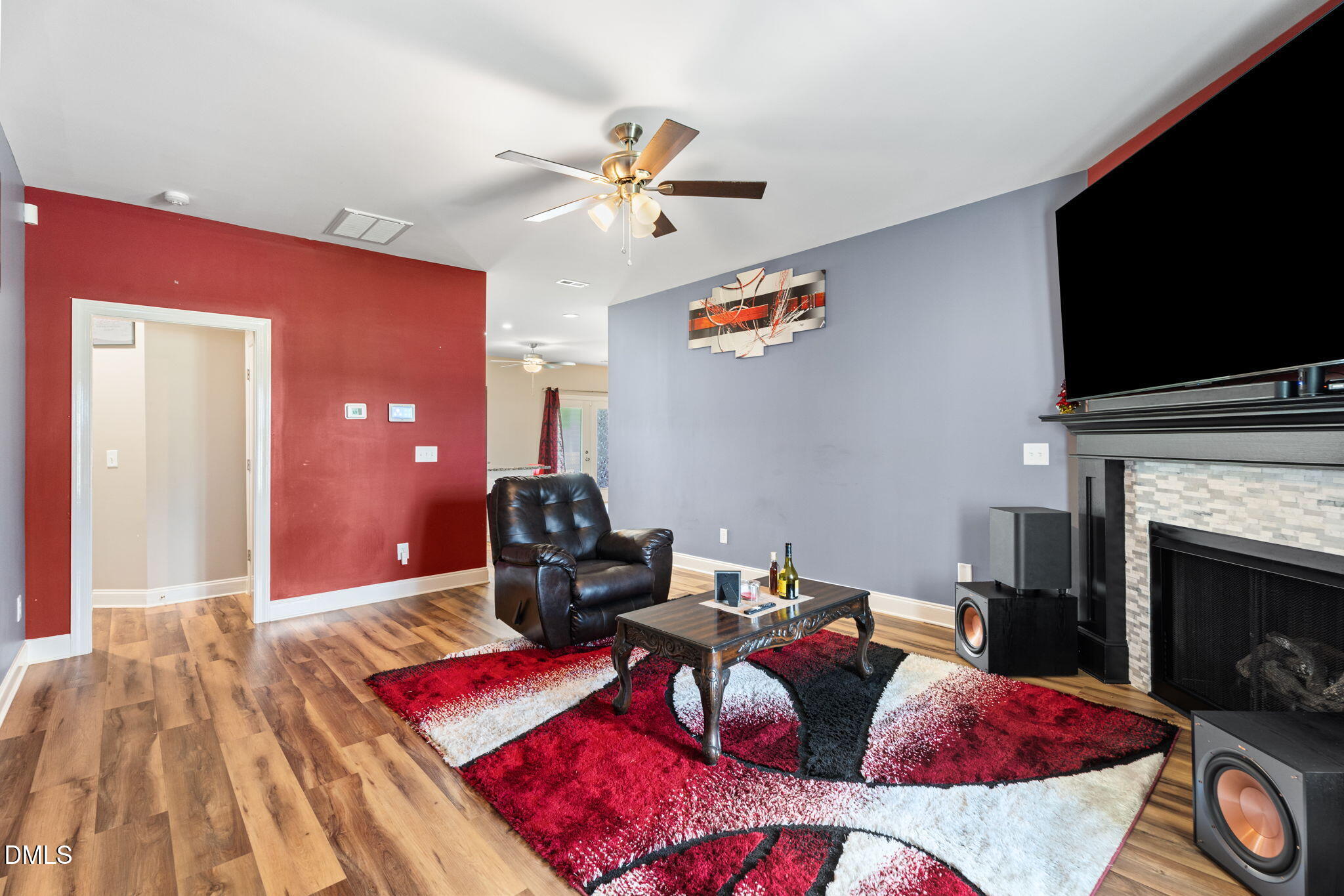 202 South 6th Street Erwin, NC 28339 - Photo 6 of 35 a living room with furniture a flat screen tv and a fireplace