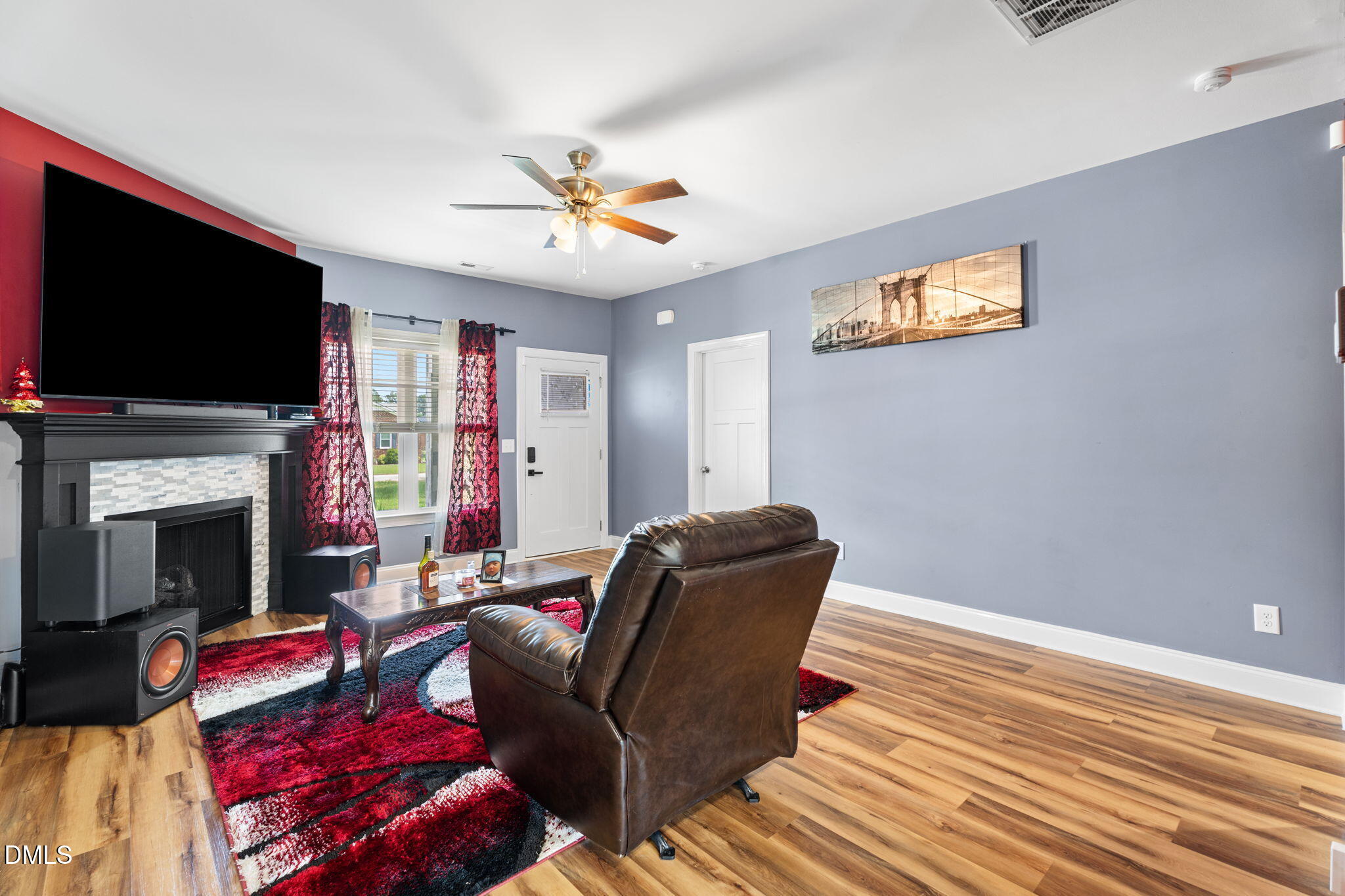 202 South 6th Street Erwin, NC 28339 - Photo 8 of 35 a living room with furniture a flat screen tv and a fireplace