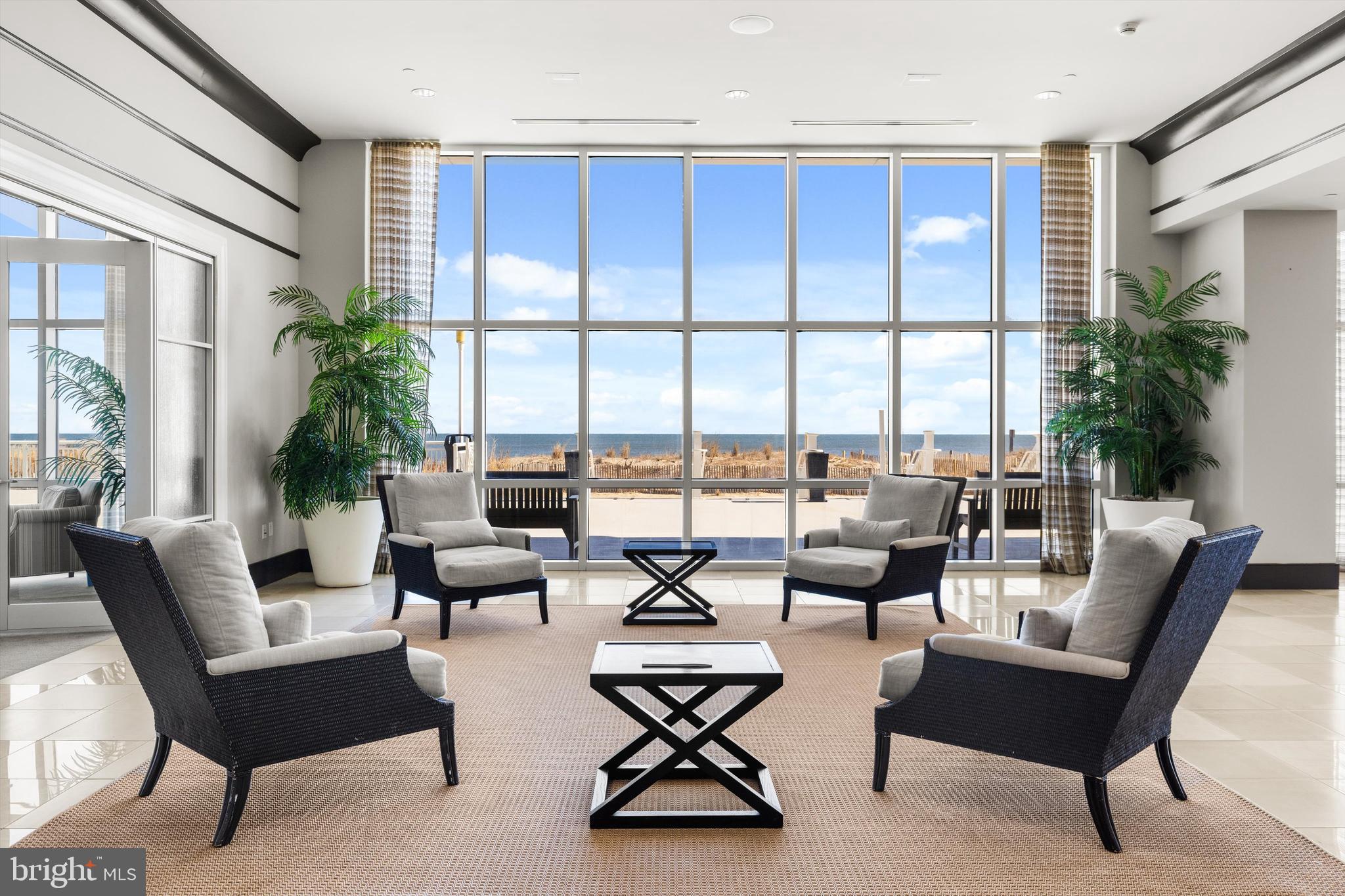 2 48th Street, Unit 1612 Ocean City, MD 21842 - Photo 61 of 90 a living room with furniture and floor to ceiling windows