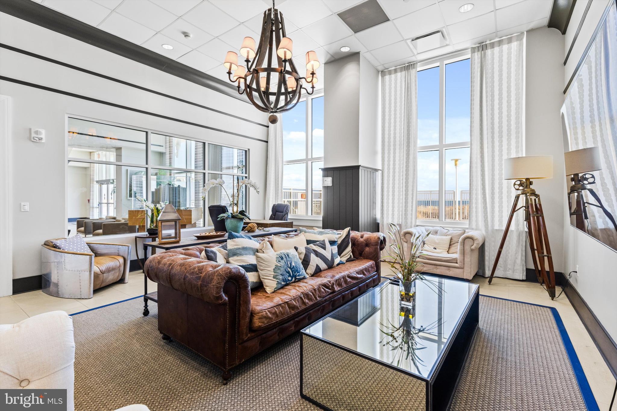 2 48th Street, Unit 1612 Ocean City, MD 21842 - Photo 63 of 90 a living room with furniture flat screen tv and a large window