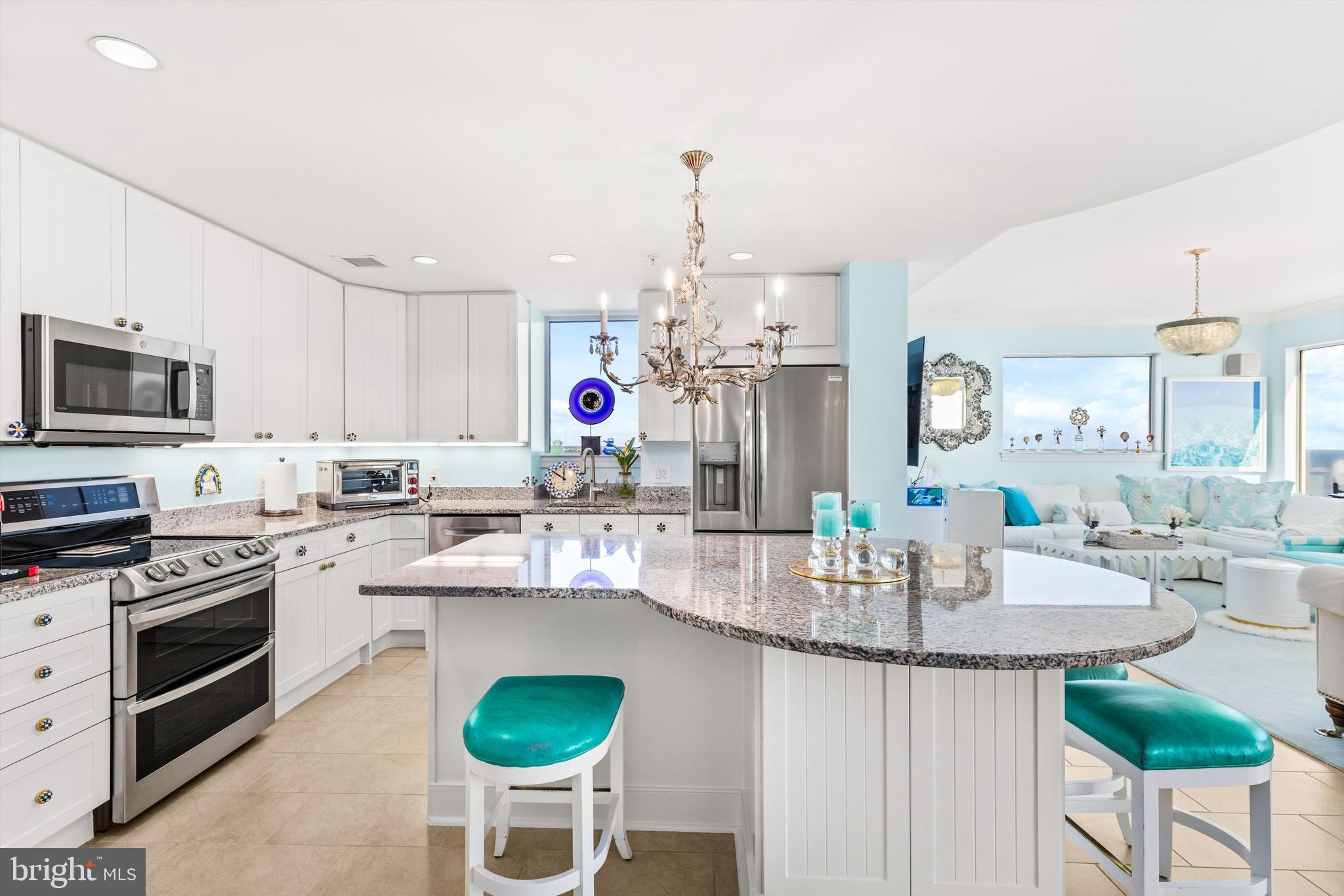 2 48th Street, Unit 1612 Ocean City, MD 21842 - Photo 8 of 90 a kitchen with kitchen island granite countertop a sink cabinets and stainless steel appliances