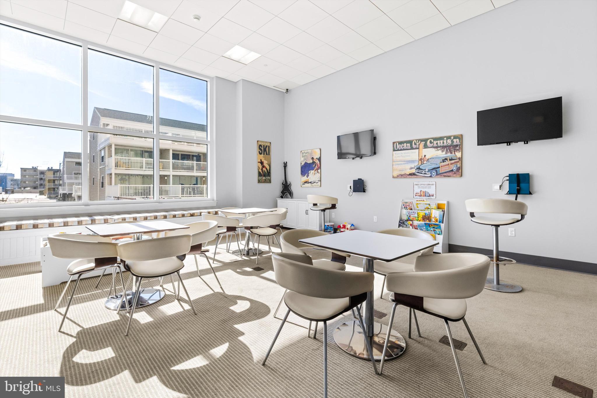 2 48th Street, Unit 1612 Ocean City, MD 21842 - Photo 81 of 90 a dining room with a table and a flat screen tv