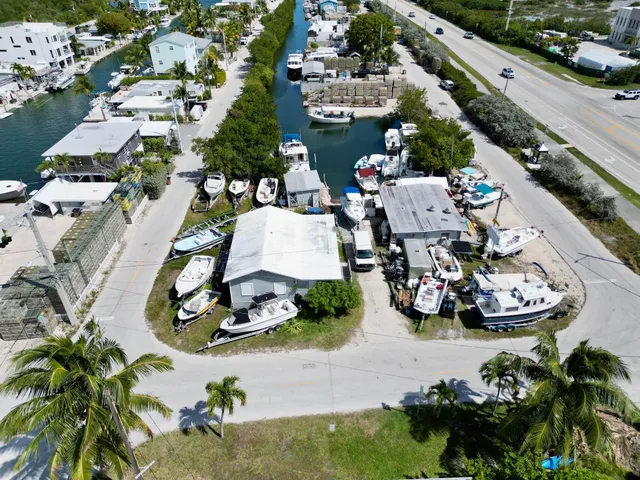 an aerial view of a house with yard seating area and car parked