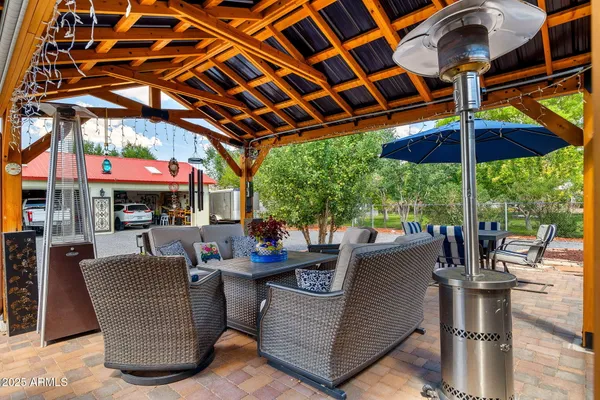 a view of a patio with a table and chairs under an umbrella