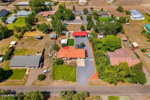 an aerial view of multiple houses with yard