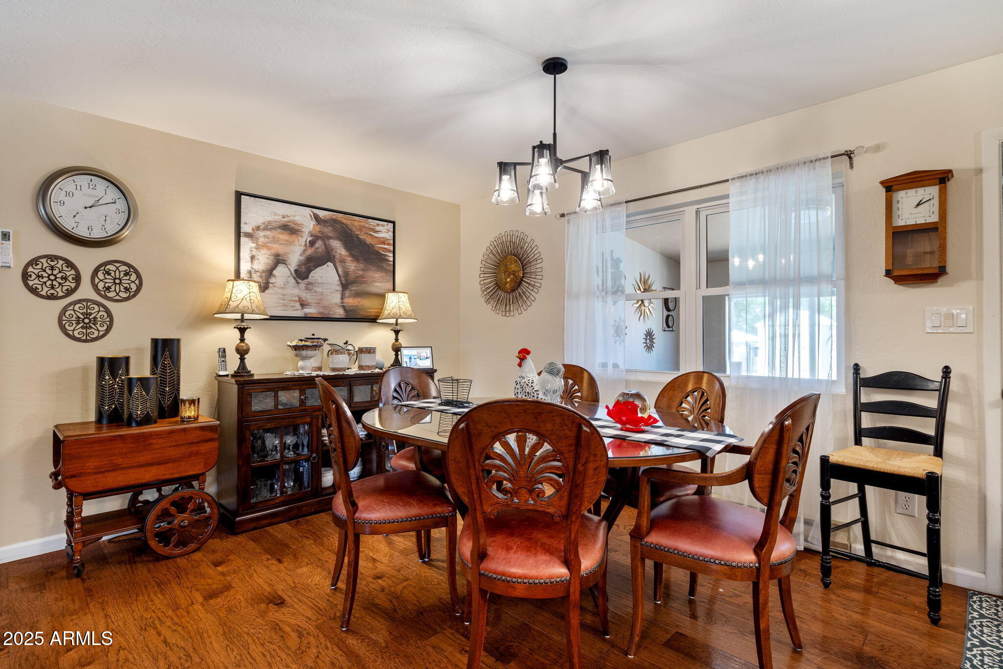 320 East 4th Avenue Eagar, AZ 85925 - Photo 6 of 38 a view of a dining room and livingroom with furniture wooden floor a rug a painting and a chandelier