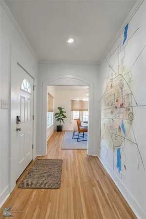 a view of a hallway view with wooden floor and living room