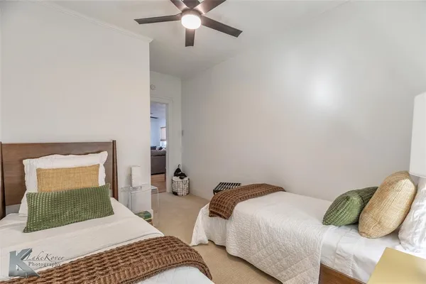 a bedroom with a large bed and a chandelier