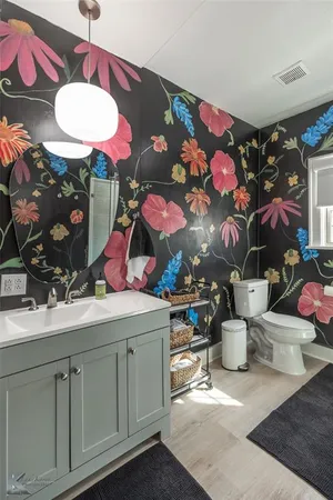 a bathroom with a sink mirror and vanity
