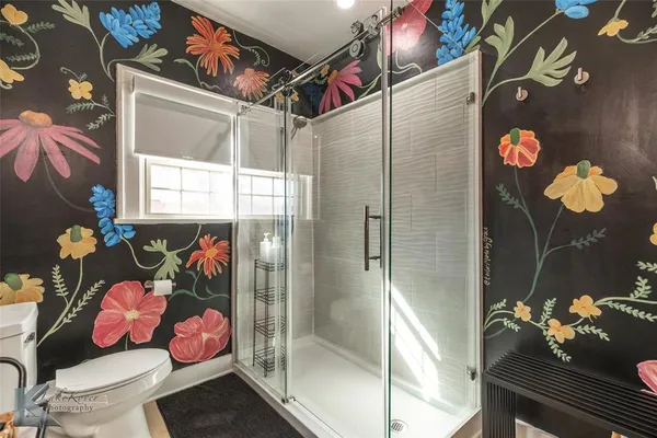a bathroom with a shower and a toilet