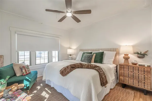 a bedroom with bed and wooden floor