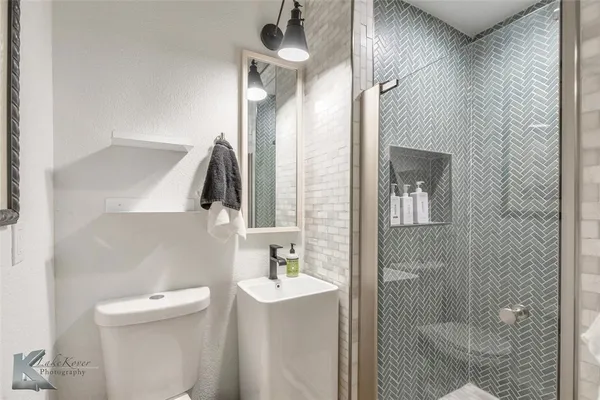 a bathroom with a toilet sink and shower