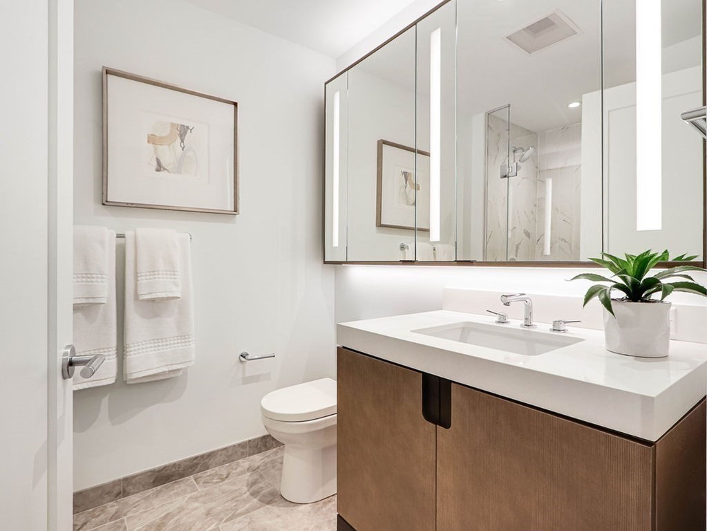 380 Harrison Avenue, Unit 12J Boston, MA 02118 - Photo 15 of 42 a bathroom with a toilet sink and mirror