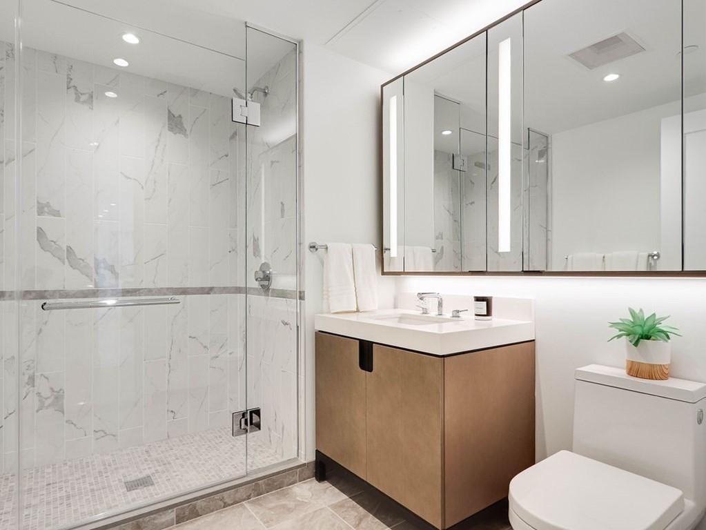 380 Harrison Avenue, Unit 12J Boston, MA 02118 - Photo 17 of 42 a bathroom with a toilet sink and shower