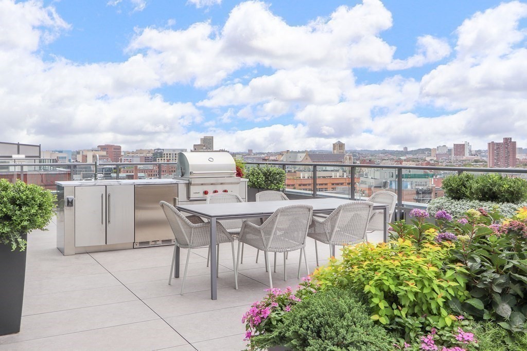 380 Harrison Avenue, Unit 12J Boston, MA 02118 - Photo 5 of 42 a view of a patio with table and chairs and potted plants