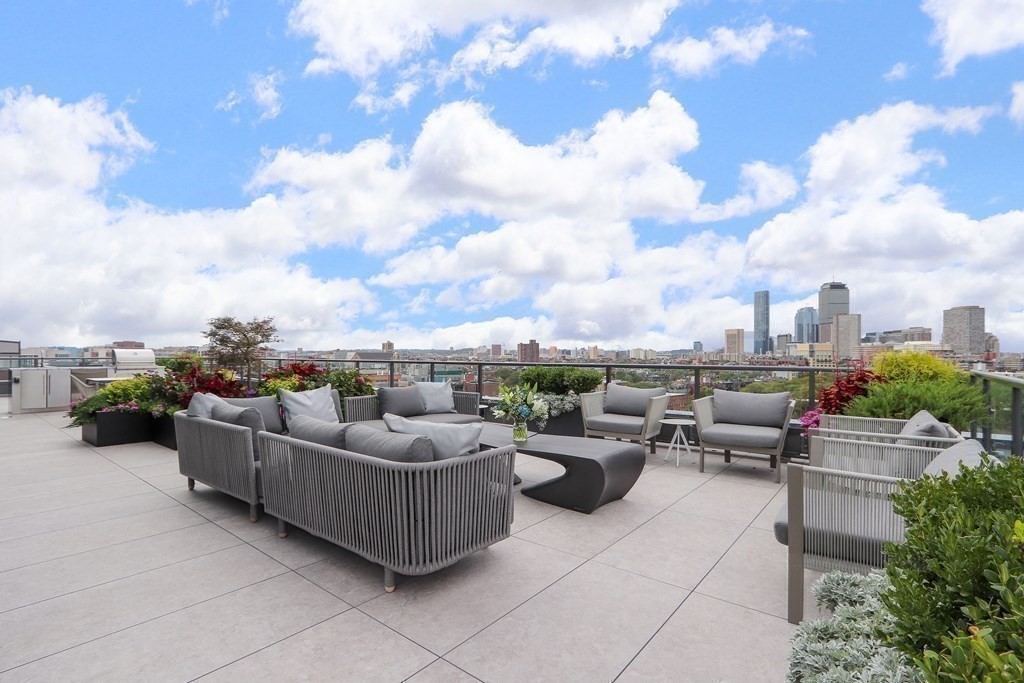 380 Harrison Avenue, Unit 12J Boston, MA 02118 - Photo 6 of 42 a view of a roof deck with couches and potted plants