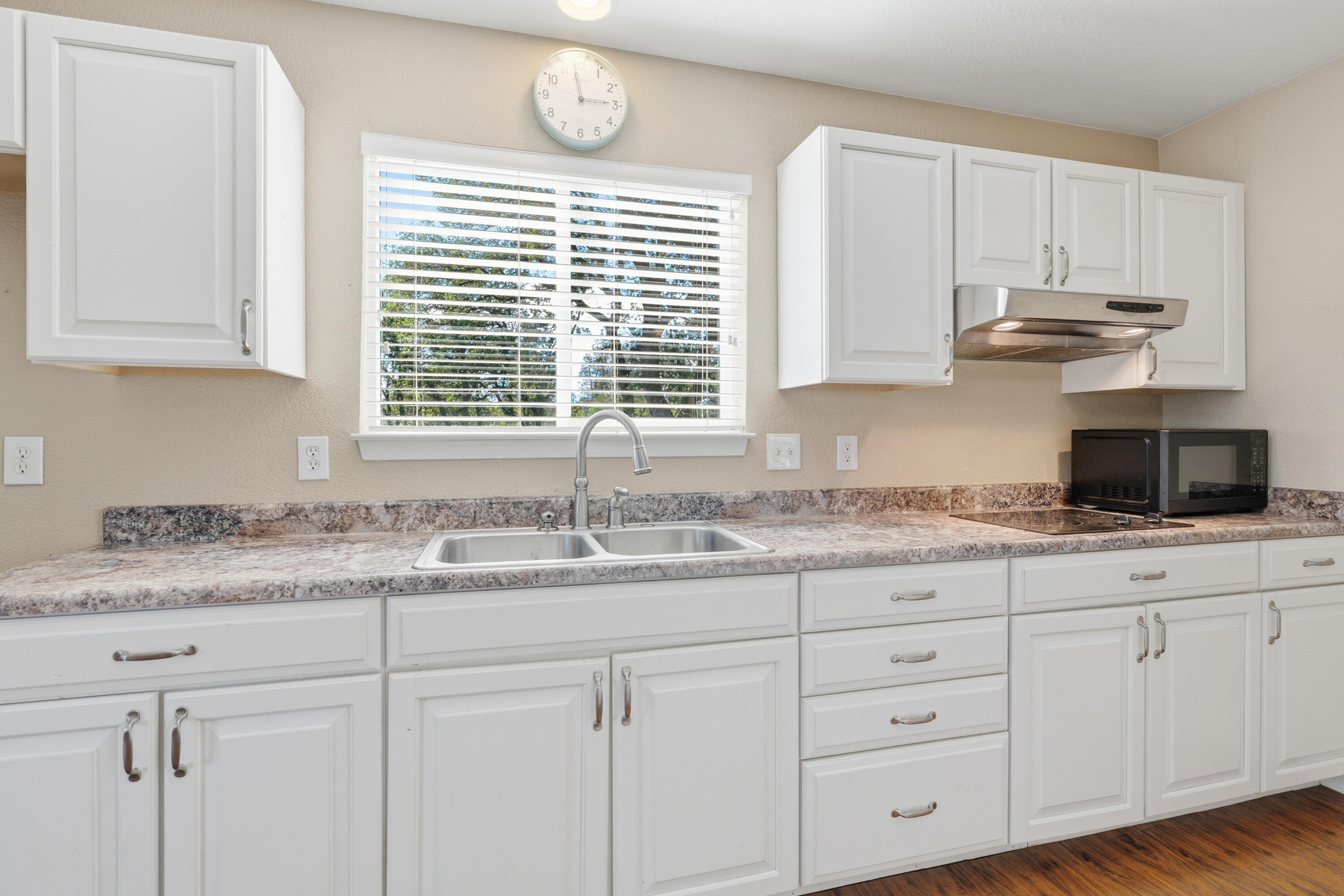 11385 Easy Street Redding, CA 96003 - Photo 38 of 55 a kitchen with granite countertop white cabinets and a window