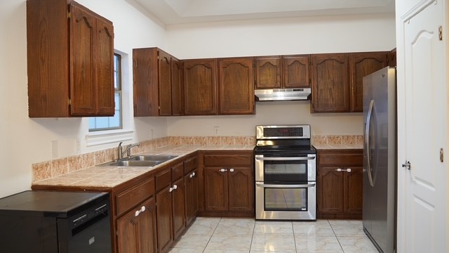 710 West Viggo Street Hebbronville, TX 78361 - Photo 10 of 27 a kitchen with stainless steel appliances granite countertop a stove and a refrigerator