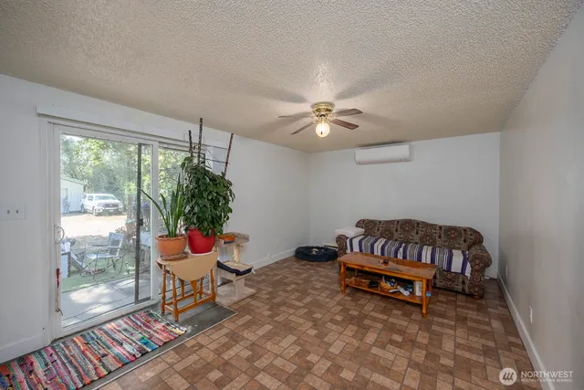 a living room with furniture and a potted plant