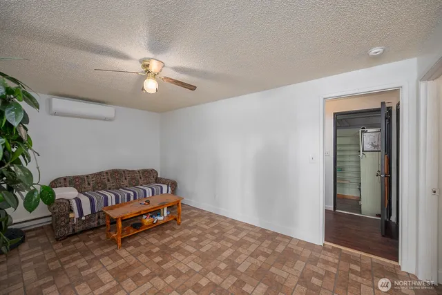 a living room with furniture and a potted plant