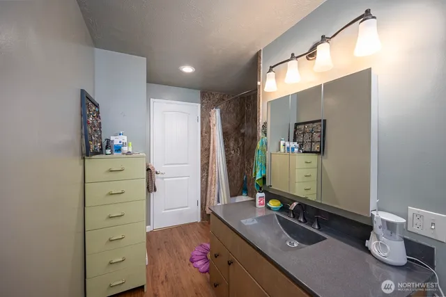 a bathroom with a sink vanity and mirror
